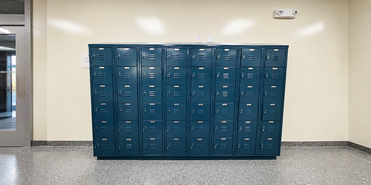 Blue metal storage lockers in a clean indoor hallway.